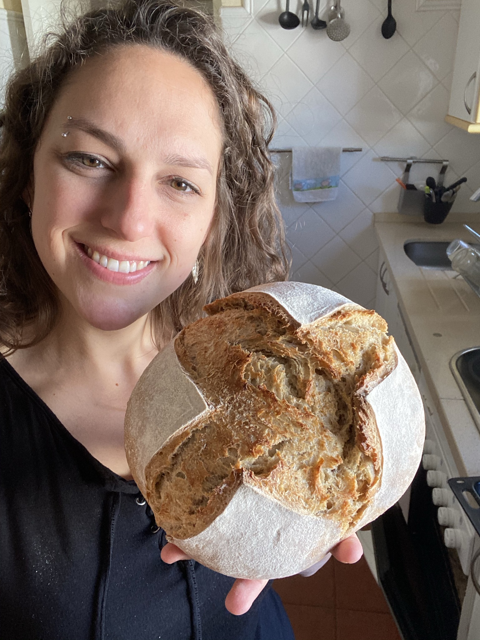 Stephanie holding homemade sourdough bread